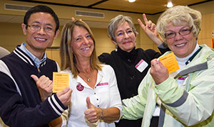 Four people with thumbs up. 