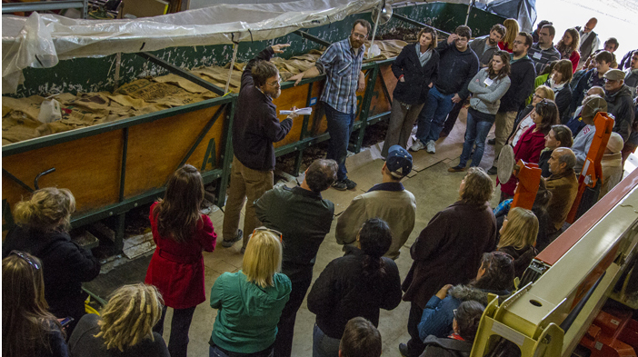 Professor Ryan Perroy explains vermicomposting system to a group of faculty, staff and students from UW System schools.