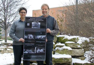 UW-La Crosse history major Sophia Lorent with UW-L History Professor Chuck Lee. The two hold her poster highlighting windows from the former Doerflinger’s department store. 