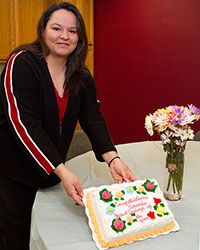 Amanda with cake and flowers.