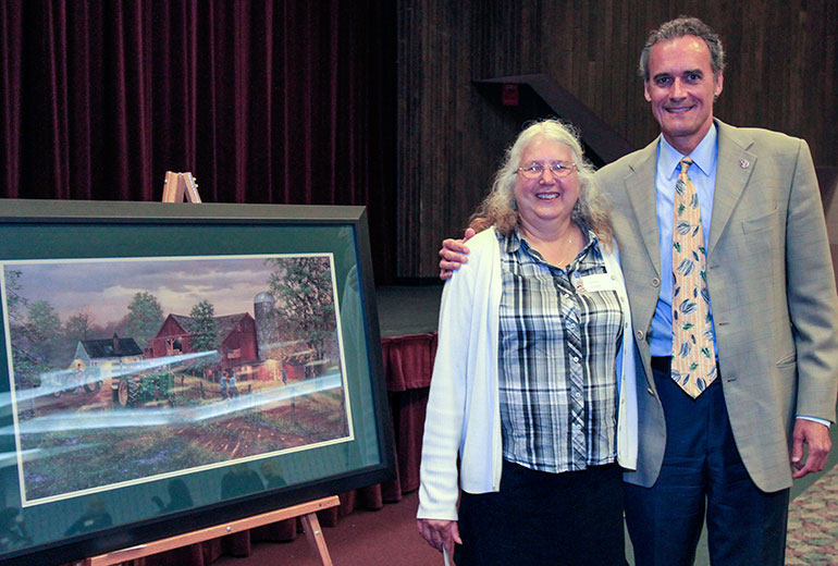 Susan Grebel with Joe Gow in front of picture.