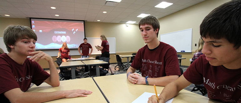 Students talking at table.