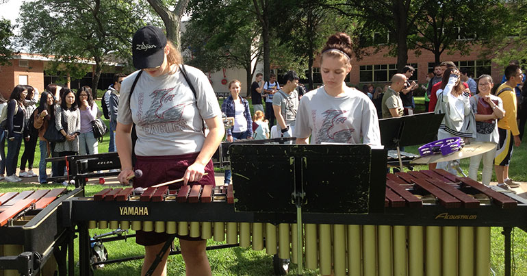 Musicians in front of students.