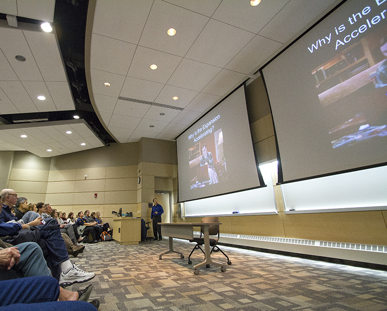 Photo of Riess presenting.