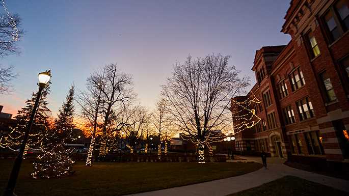 The trees in front of Graff Main Hall adorned with lights at sunset.
Read more →
