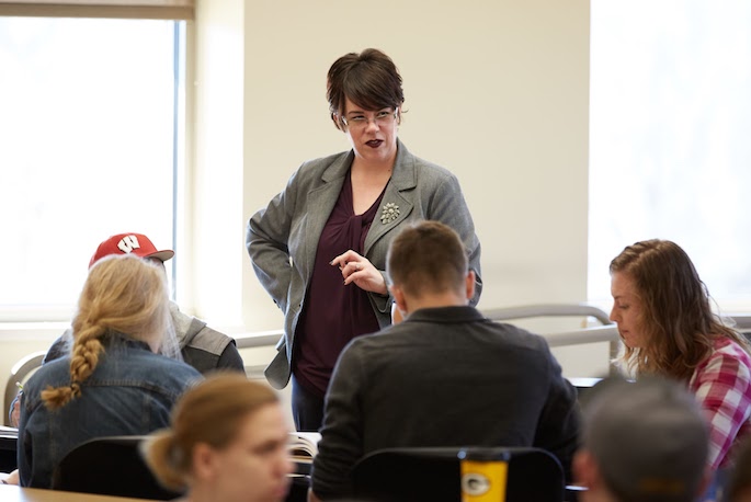 Image of Laurie speaking to students in a class.