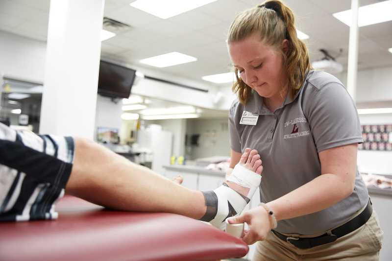 UWL athletic training student performs a foot taping in this undated photo. 