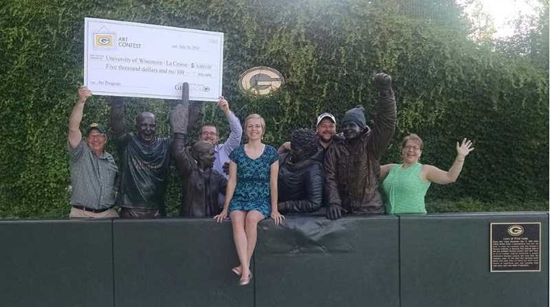 UWL Art student Carolyn Myers, center, does a Lambeau Leap after winning the second annual Green Bay Packers student art competition. “My piece was done to honor the transition of the Packers’ stadium, players, uniforms and fans,” she explains. The win brought home $5,000 to the UWL Art Department. 
Read more →
