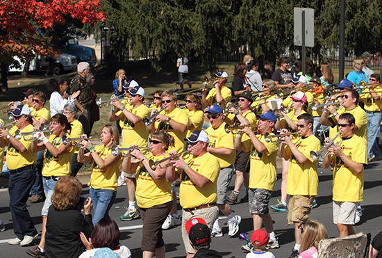UW-L Alumni Band members walking and playing.
