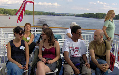 New Amity interns Pilar Pino,Spain, left; and Stevy Claire, France, second from right; chat with 2007-08 interns Salka Blotz, Germany: and Julien Neola, France; during a La Crosse Queen Excursion Aug. 28.