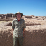 UW-L Senior Thatcher Rogers poses in front of prehistoric architectural remains in the desert.