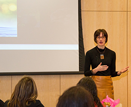 Image of Ariel Beaujot talking in front of a crowd.