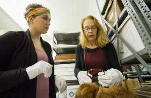 Ariel Reke with La Crosse Historical Society's Peggy Derrick looking at an artifact.