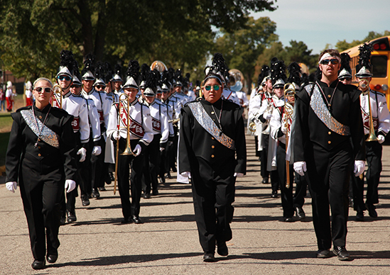 Image of marching band being led by drum majors. 