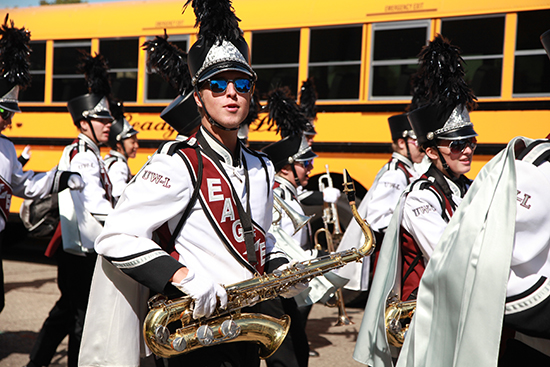 Image of someone marching with a saxaphone.