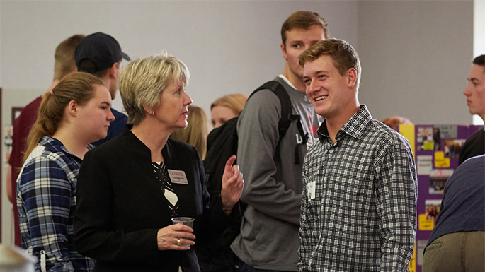 UWL Junior and Accounting Major Jon Barnes talks with CBA Dean Laura Milner during the annual CBA Meet & Greet. Barnes says the CBA has given him many opportunities to lead, volunteer and be part of a team.