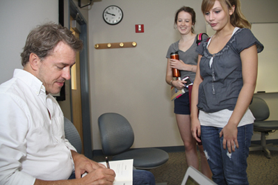 Author Colin Beavan signing a book. 