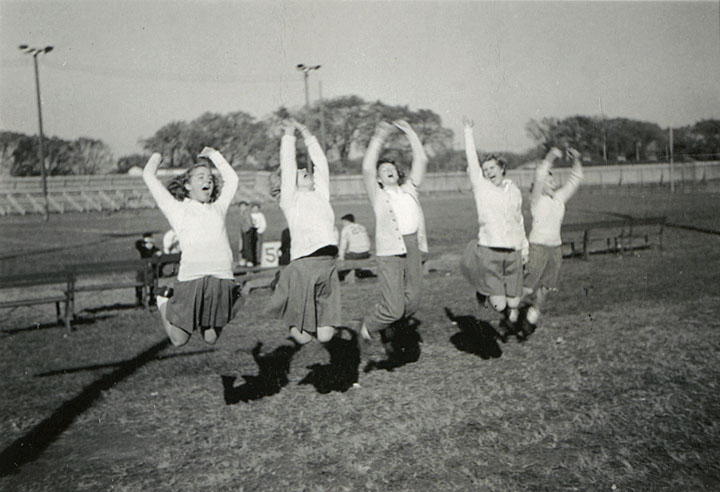 Students jumping in photo. 