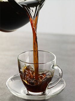 Coffee being poured into cup. 