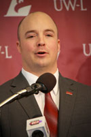 Headshot of Joel Dettwiler at podium.