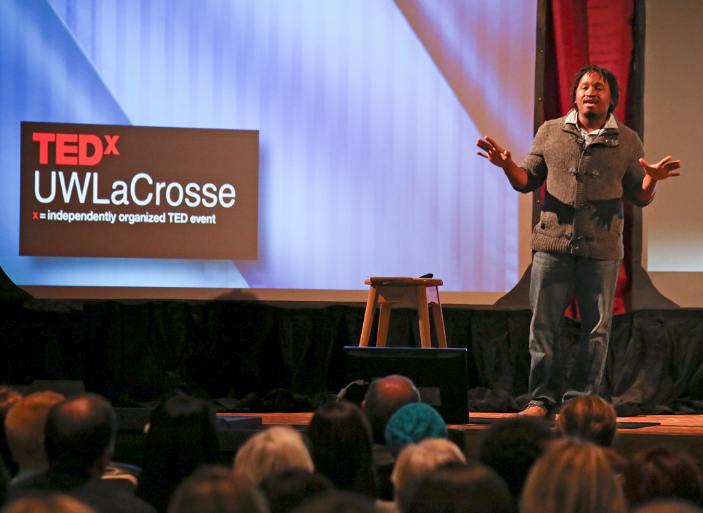 UW-L student Dewayne Wrencher pictured speaking on the stage of Graff Main Hall auditorium.