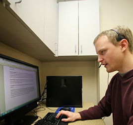 UW-L student typing on a computer. 