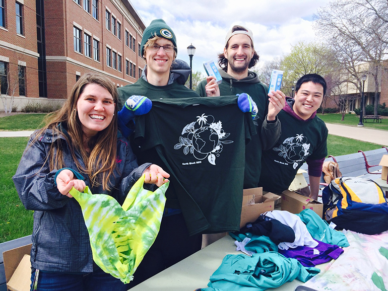 Students with Earth Day items. 