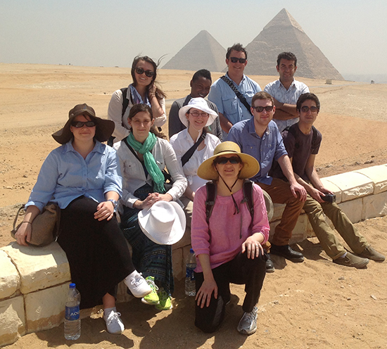 Assistant Professor Heidi Morrison along with nine students pose in from of Egyptian pyramids. 