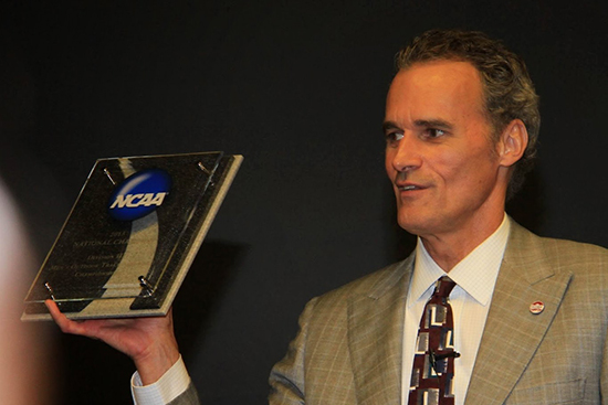 Chancellor Gow holds NCAA award.