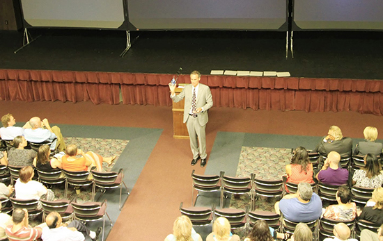 Chancellor Gow in front of crowd in Valhalla.
