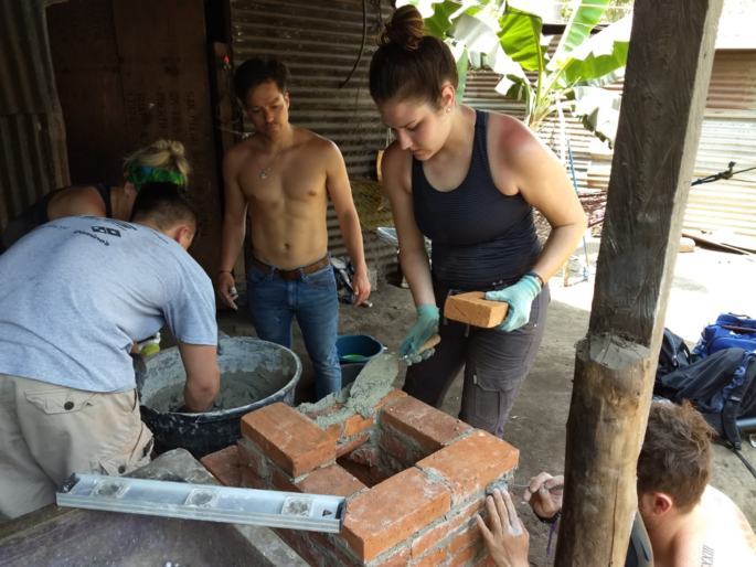 Kitt Drewiske builds a ‘Rocket Stove’ with Mitchell Jaeger, Claire Lofald, Enrique Haessler, and Carlitos Galvez.