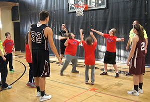Children and basketball playing shooting baskets.