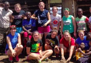 UW-L students pictured with Kenyan family outside the home they built for the family.