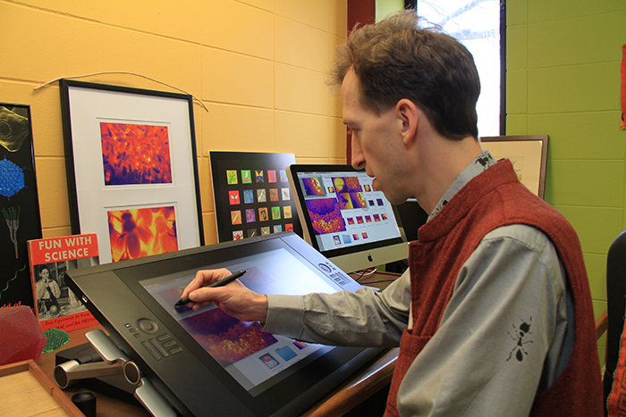 Image of Barrett Klein working on his computer. 