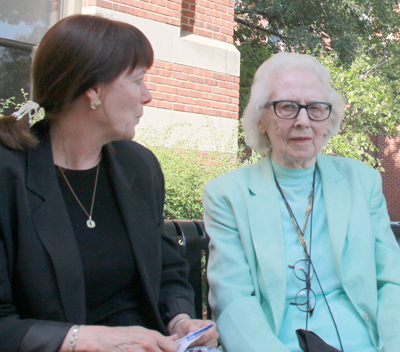 Ruth Kramer, right, in front of Graff Main Hall talking with Registrar Chris Bakkum.