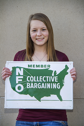 Miranda Kunees holds the NFO sign.