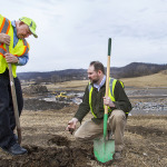Hank Koch and Paul Reyerson with shovels digging into dirt at the landfill.