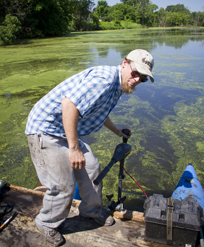 Earth Sciences Department Ryan Perroy, UW-L assistant professor of geography, sets up equipment used to collect soil samples on the La Crosse River marsh.