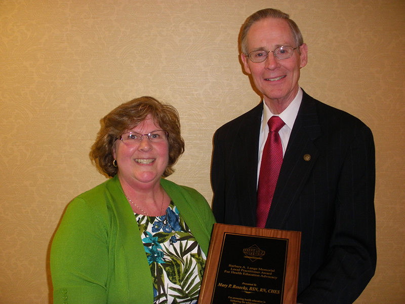 Gary Gilmore, chair of Wisconsin Health Education Network and UW-L professor of Health Education & Health Promotion, presents the Barbara A. Lange Memorial Award to Mary Rosecky, public health nurse educator for Dodge County Human Services and Health Department.