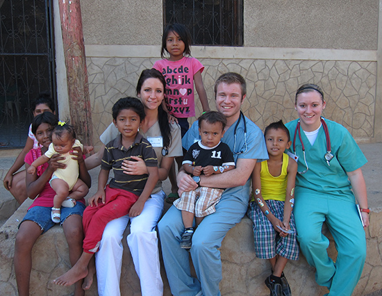 UW-L students: Nicole Reinhardt, Ryan Moncada and Hannah Lawinger surrounded by children in Nicaragua.