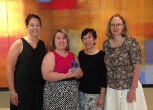 Image of several of the MOOC’s primary contributors holding the award at the conference in Boston.