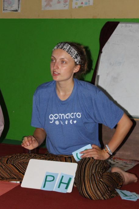 Morgan Alexander teaches letter sounds using pictures while volunteering in Nepal. She says it was fun to see English as a Second Language learning in action.