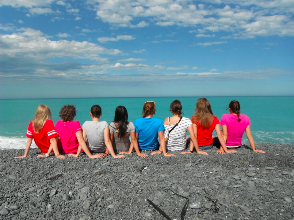 UW-L students pictured from behind looking out onto a body of water. 