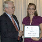 Mindy Opelt receiving award from Varian rep. 