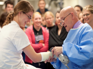 Doctor wrapping a student's wrist