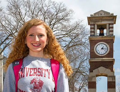 Image of Anicka Purath standing in front of Hoeschler Tower. 