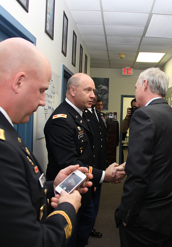 Sen. Ron Johnson greeting people in a hallway.