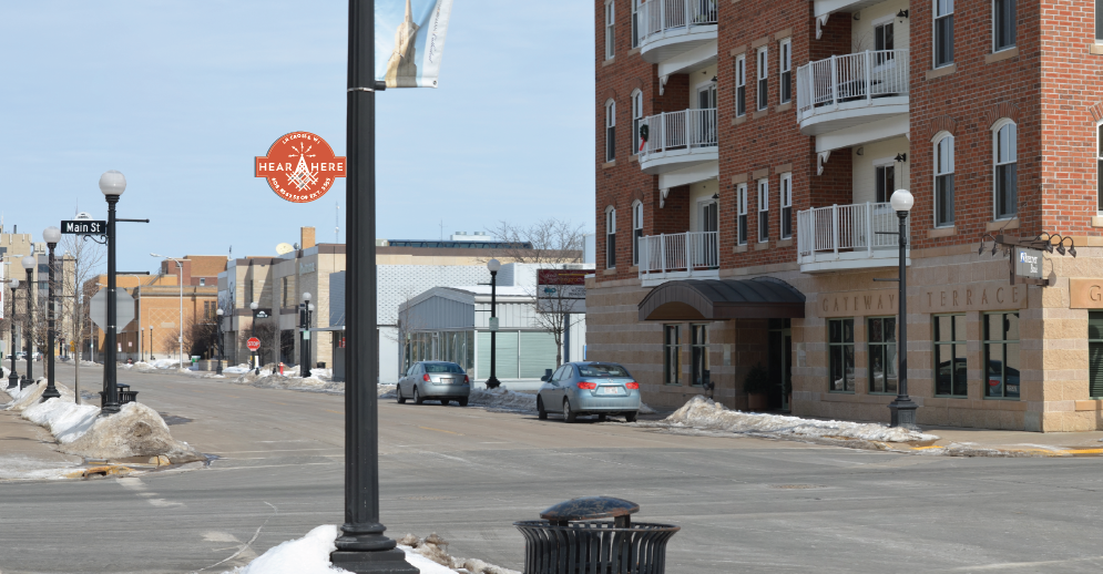 Light pole with a marker on it indicating the phone system is there. 