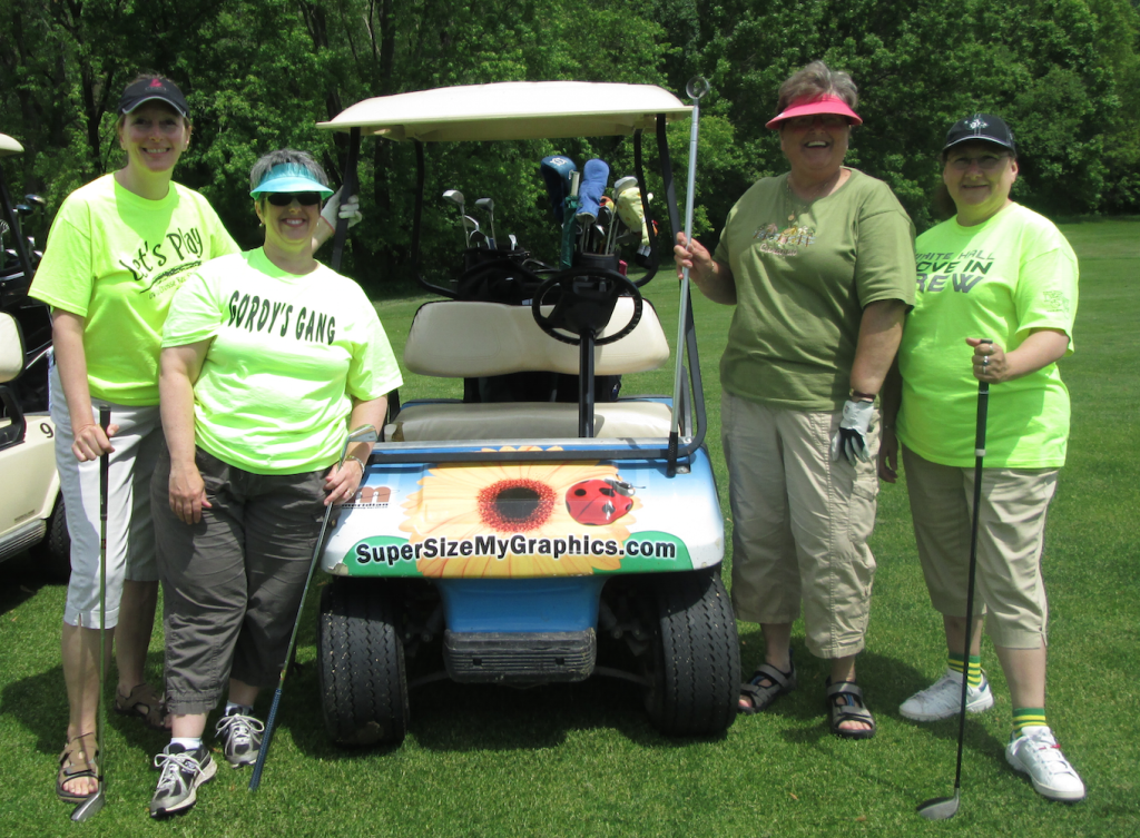 Four participants with golf cart.