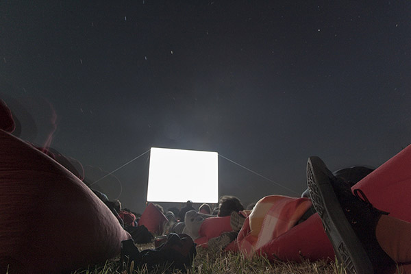 Image of screening taken from the ground where a foot is in the foreground and the screen in the background. 